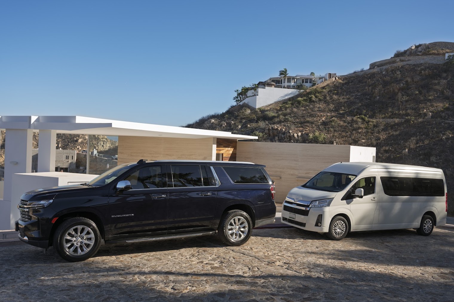 SUVs parked under the covered carport at Casa Blanca Pedregal
