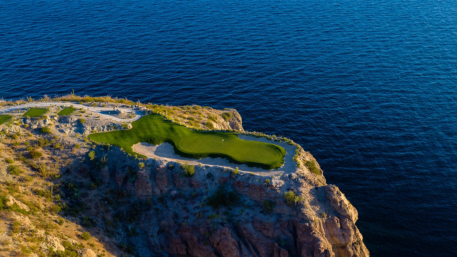 TPC Danzante Bay golf course — dramatic cliffside hole overlooking the Sea of Cortez