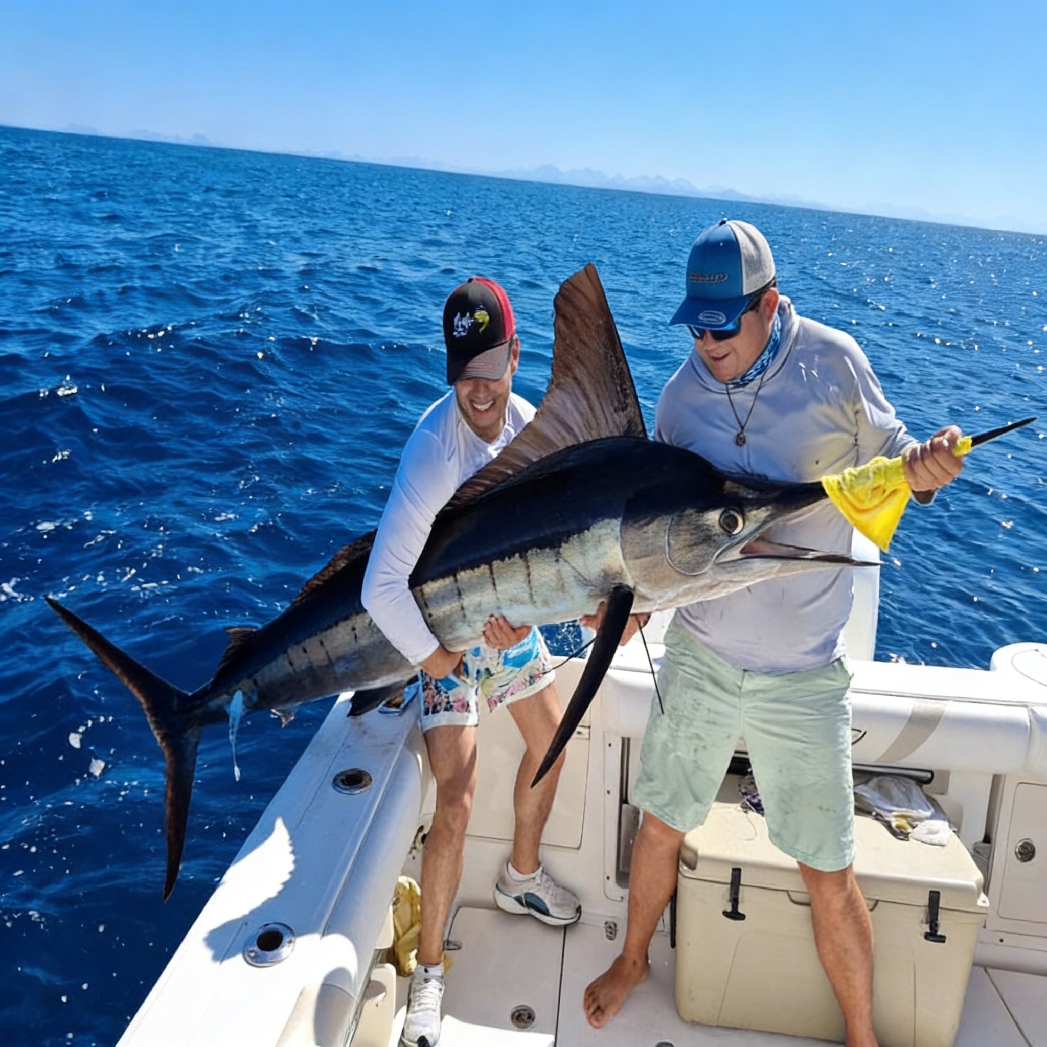 Two anglers holding a billfish on a private Loreto fishing charter in the Sea of Cortez