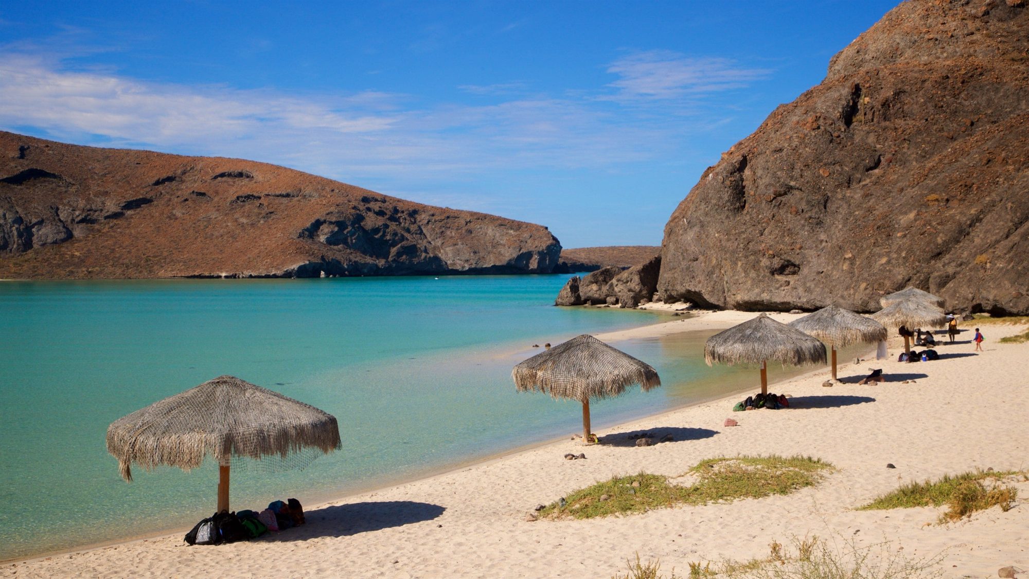 Calm turquoise water and beach umbrellas at Balandra Beach near La Paz in Baja California Sur