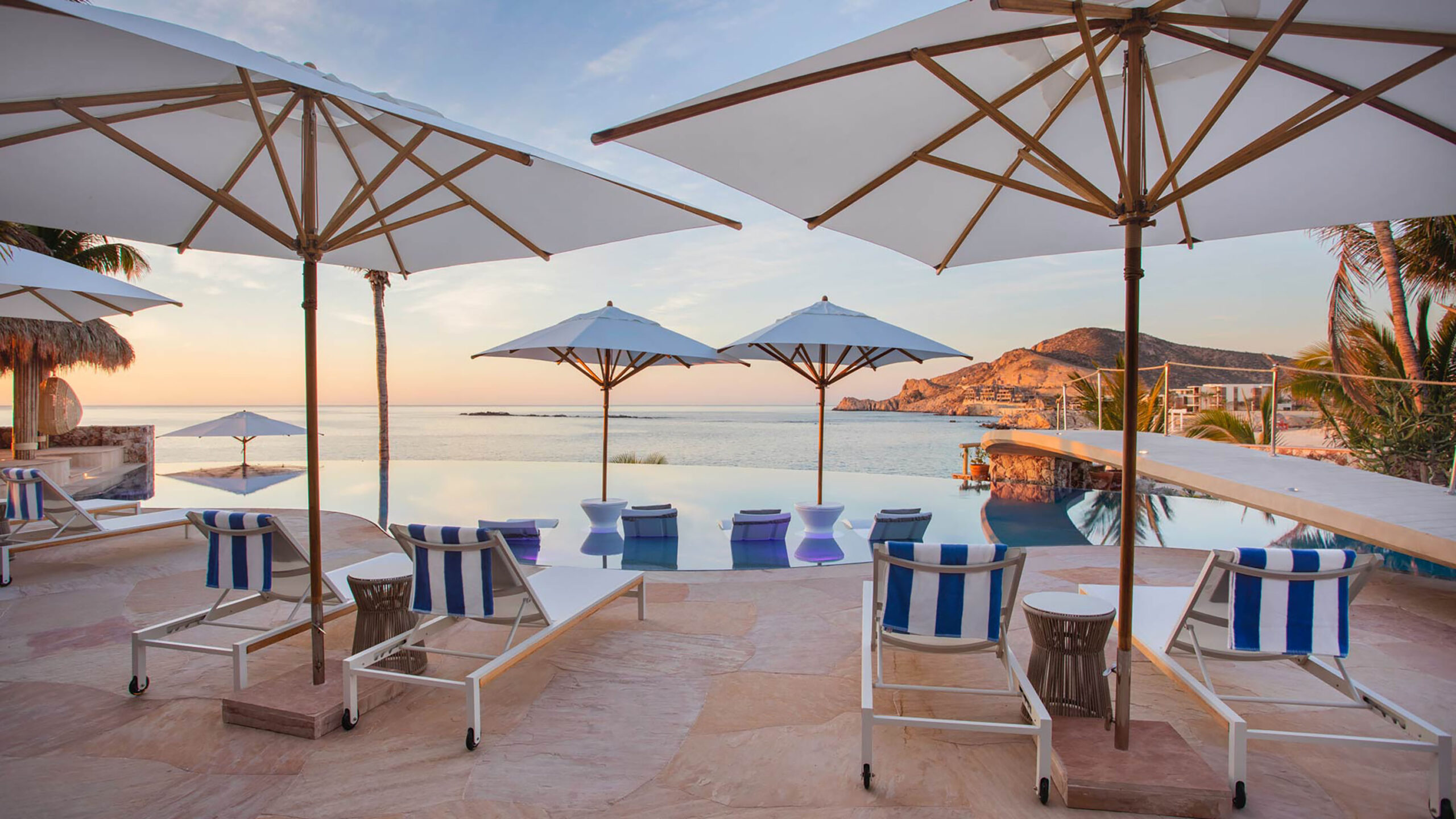Casa Cielito del Mar lounge in style by the infinity pool, where calm waters mirror the sunset and panoramic sea views stretch toward distant coastal hills