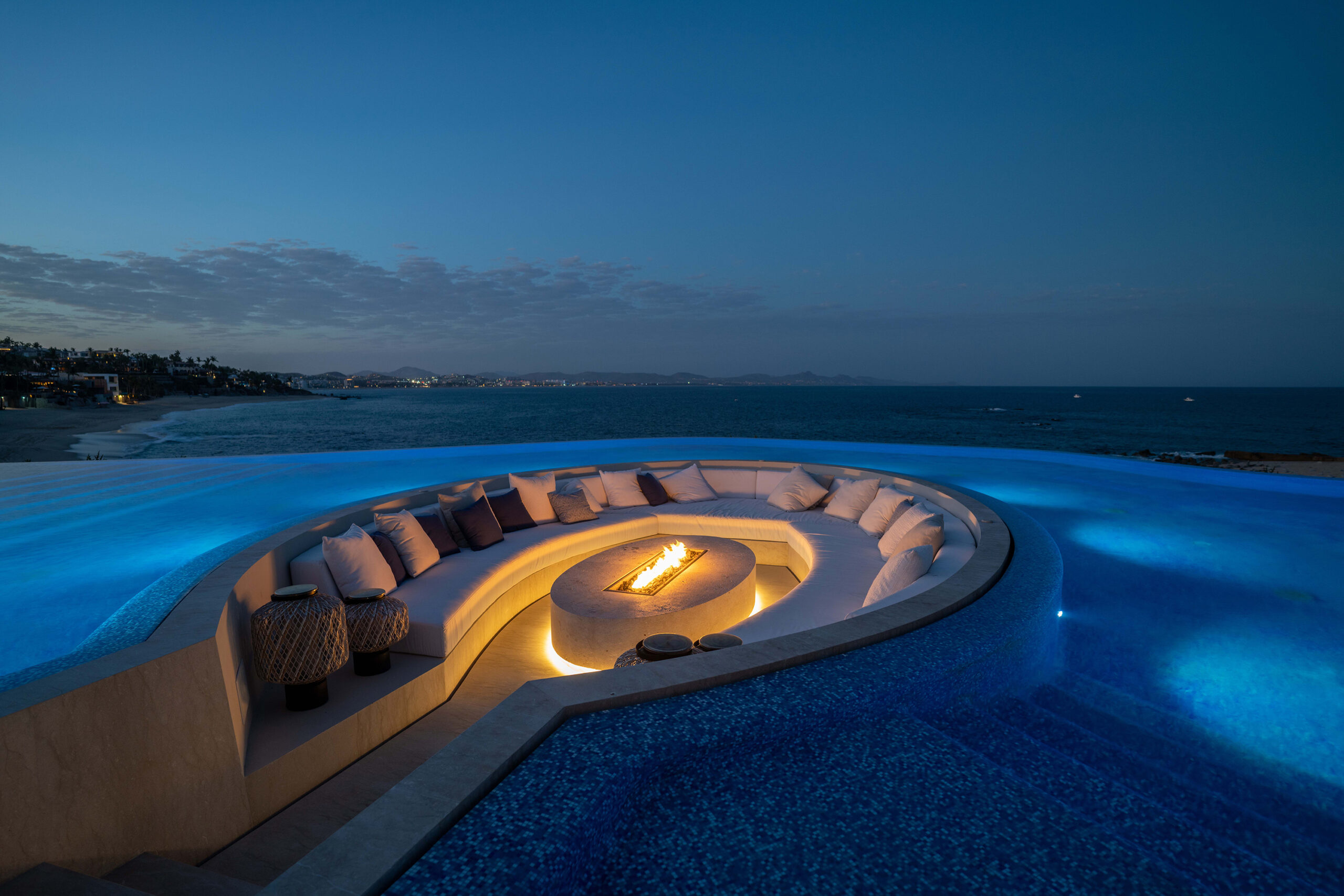 Casa Elije sit by the beautiful fire pit surround by the pool and ocean views in Palmilla Los Cabos