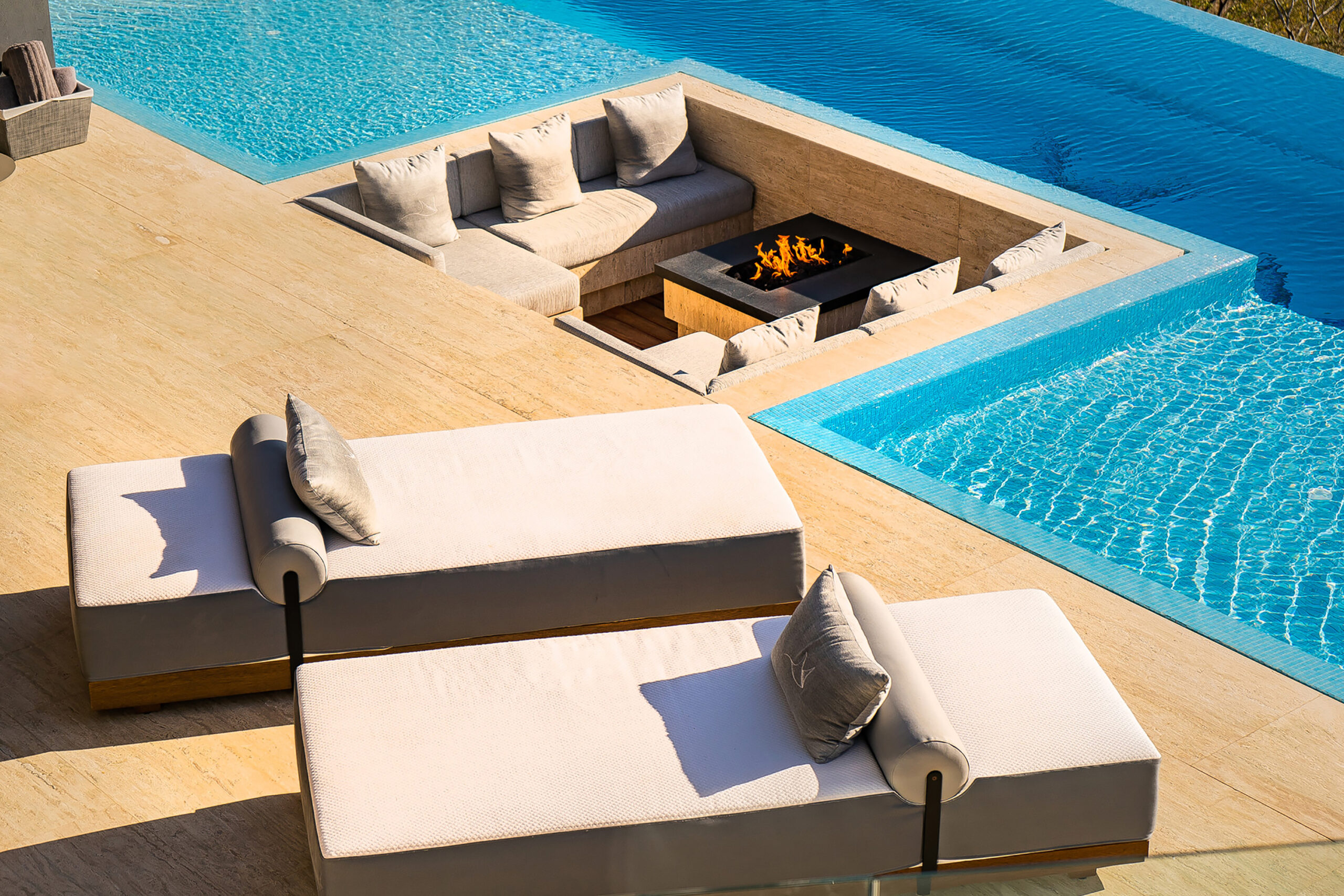 Maison de Cortes patio with infinity pool and built-in seating area in Pedregal Pacific, Onsite Villa Staff Los Cabos