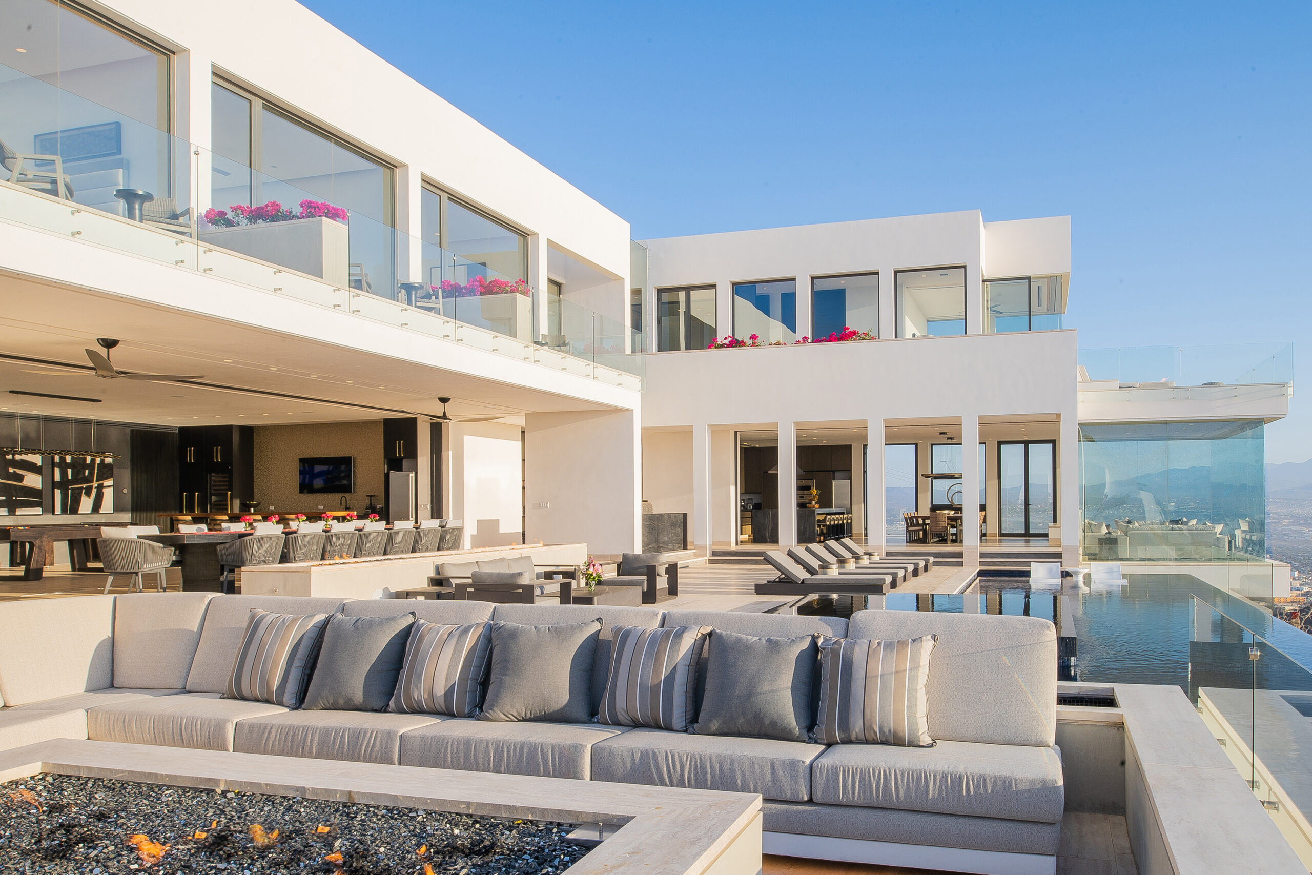 Villa Aurora poolside with incredible ocean and city views at night in Pedregal Pacific, Marina View Los Cabos