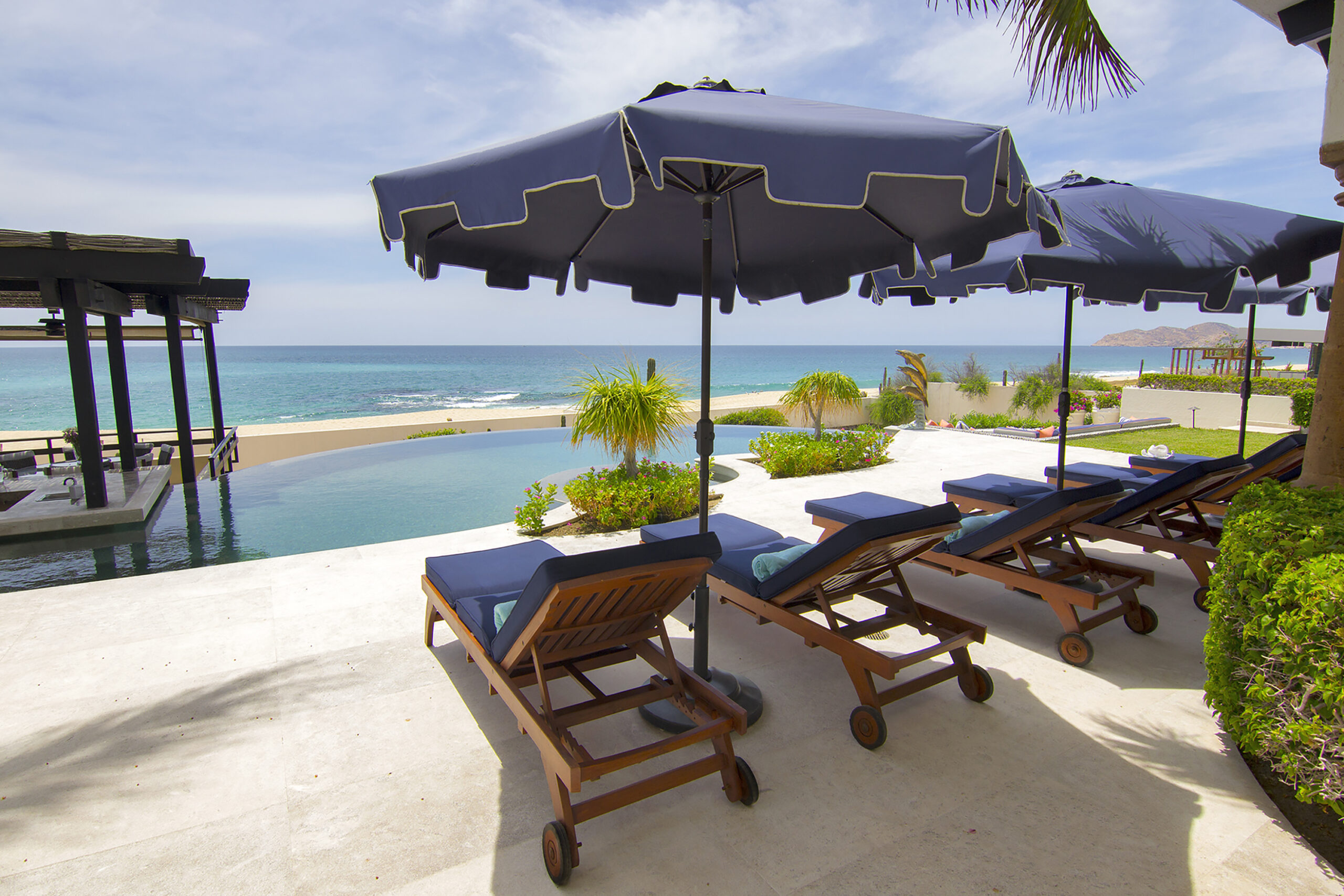 Villa Delfines lounge poolside with a beachfront view in Cabo Real, Beachfront Los Cabos