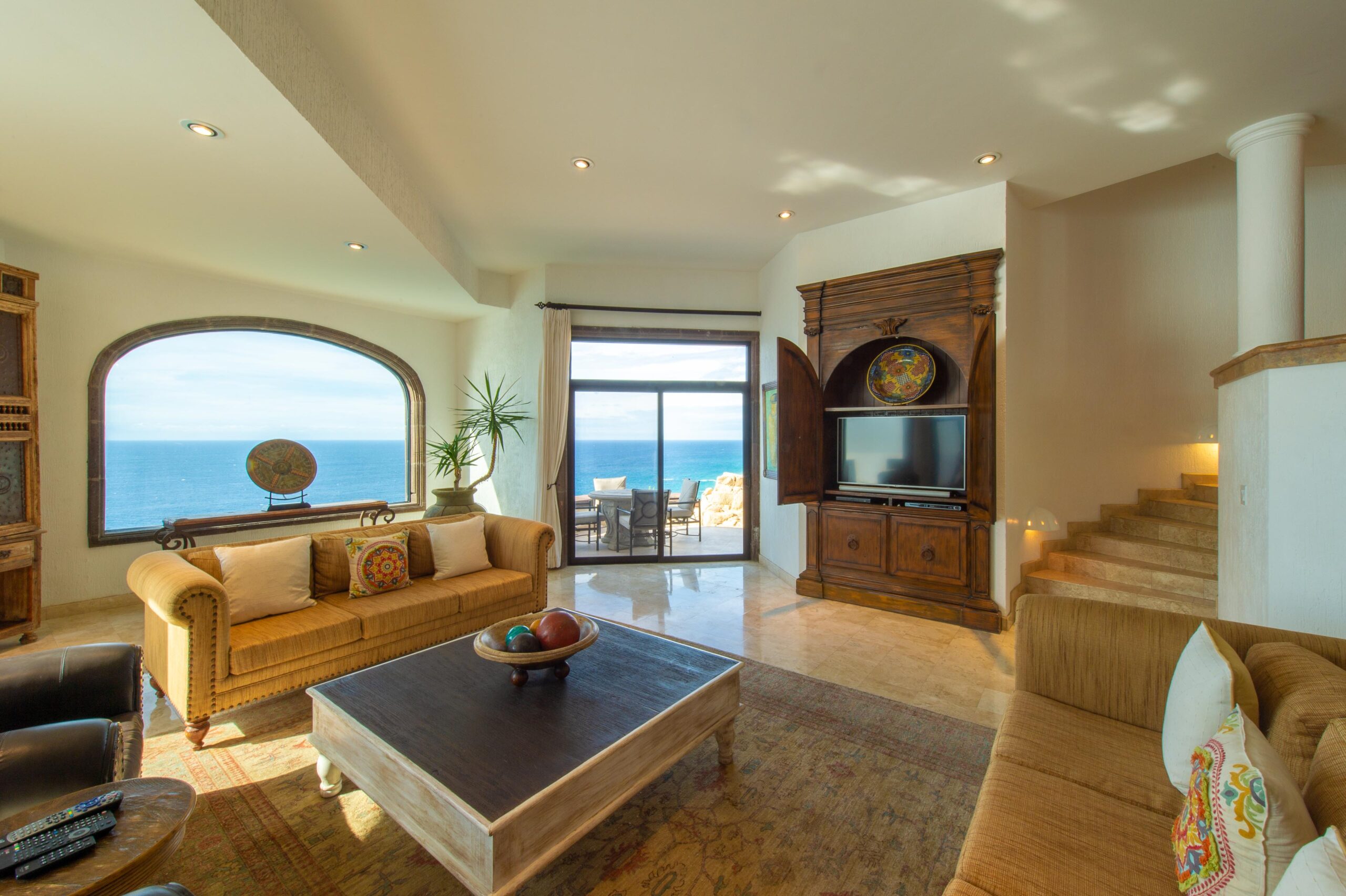 Villa Grande living room with TV and ocean views in Pedregal Pacific, Oceanfront Los Cabos
