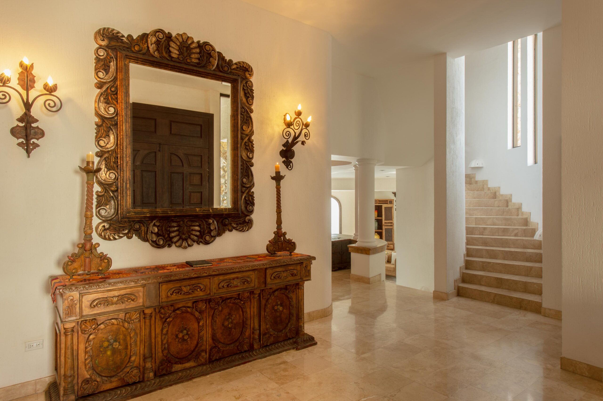 Villa Grande ornate mirror and furniture with stairway to bedrooms in Pedregal Pacific, Oceanfront Los Cabos
