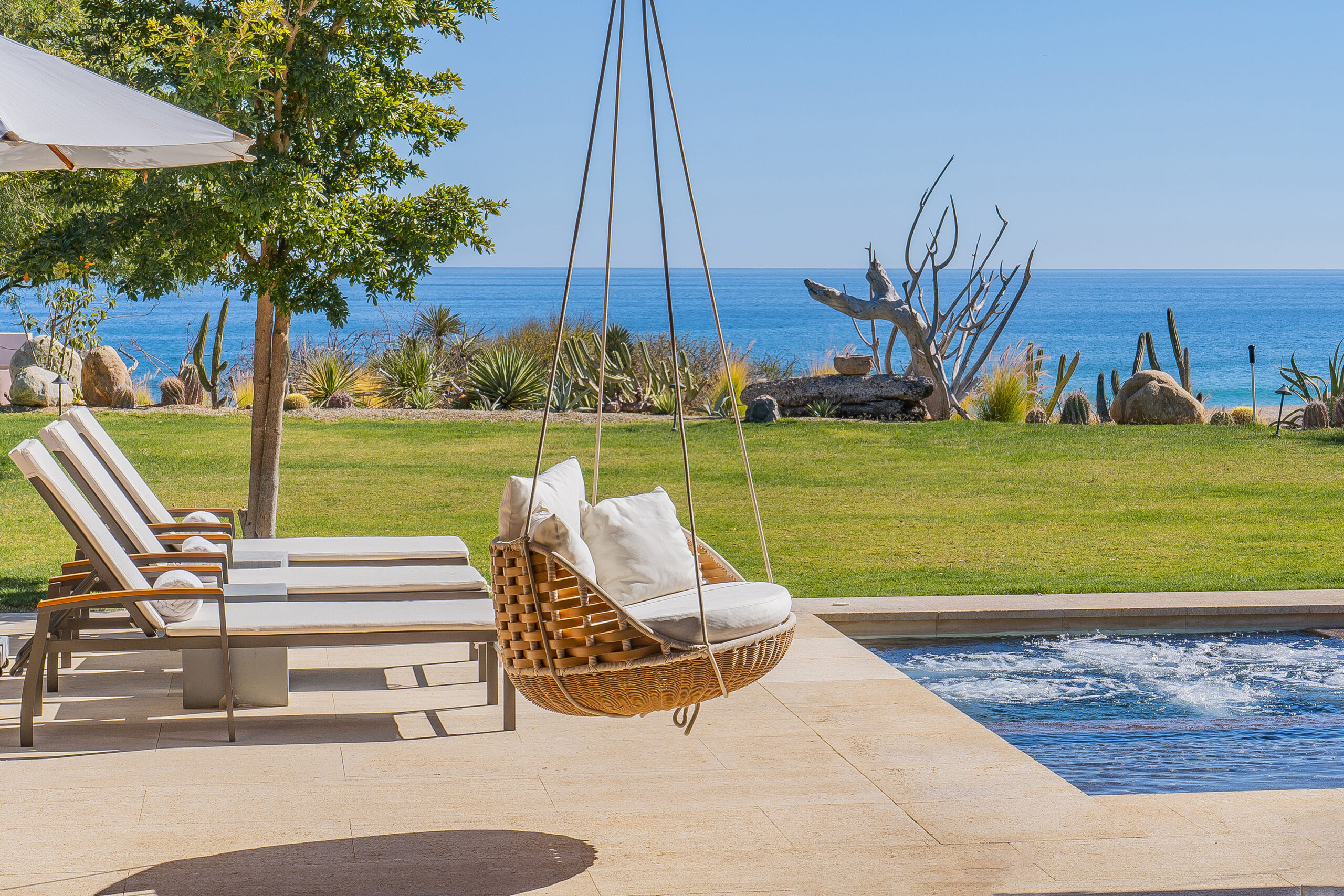 West Enclave 8 poolside patio with hammock and ocean view in Puerto Los Cabos, Family Friendly Los Cabos