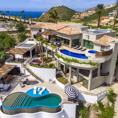 Aerial view of Casa Del Norte in Pedregal with two pools and the Pacific Ocean beyond